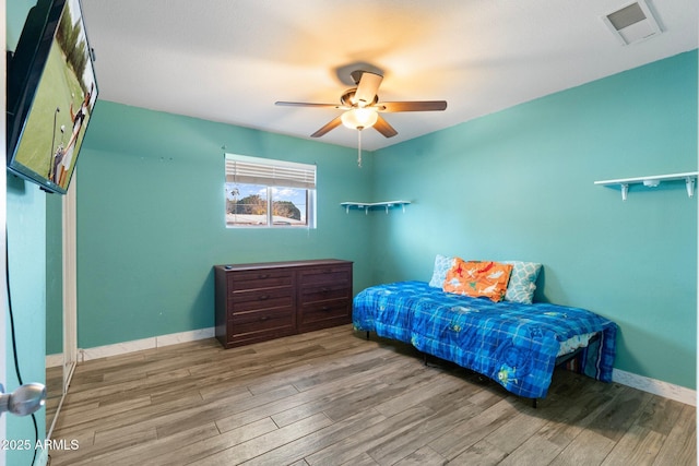 bedroom with hardwood / wood-style floors and ceiling fan