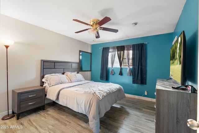 bedroom with ceiling fan and light hardwood / wood-style floors