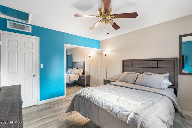 bedroom featuring light hardwood / wood-style floors and ceiling fan