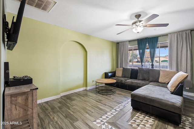 living room featuring ceiling fan and wood-type flooring