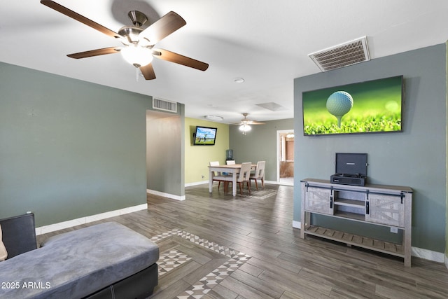 living room featuring hardwood / wood-style floors and ceiling fan