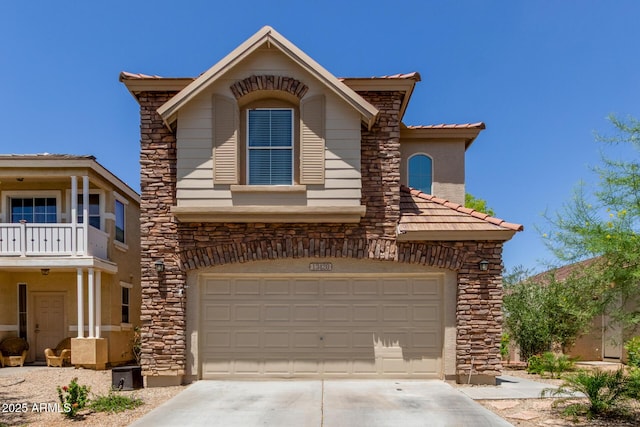 13420 W Berridge Ln, Litchfield Park, AZ 85340 - view of front of home featuring stone siding, concrete driveway, and a garage