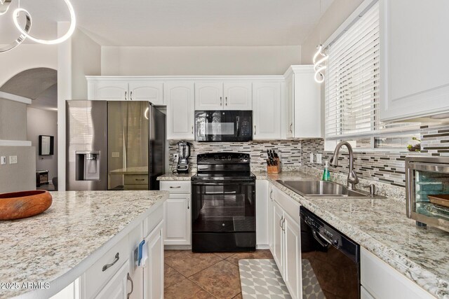 13420 W Berridge Ln, Litchfield Park, AZ 85340 - kitchen with black appliances, a sink, white cabinets, and decorative backsplash