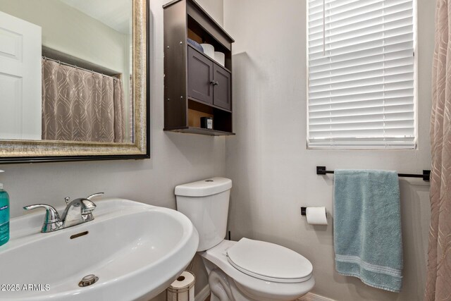13420 W Berridge Ln, Litchfield Park, AZ 85340 - full bathroom featuring a sink, toilet, and a shower with shower curtain