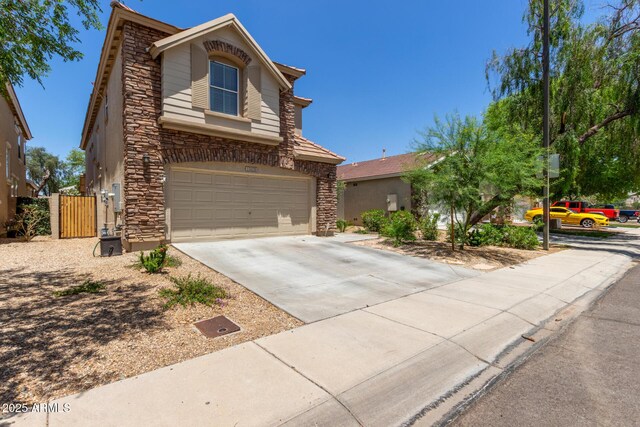 13420 W Berridge Ln, Litchfield Park, AZ 85340 - view of front of property with stone siding, a garage, and driveway