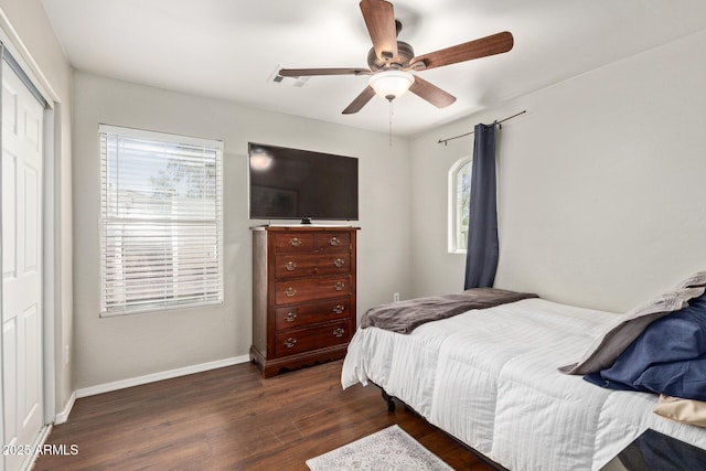13420 W Berridge Ln, Litchfield Park, AZ 85340 - bedroom with dark wood-style flooring, baseboards, a closet, and a ceiling fan