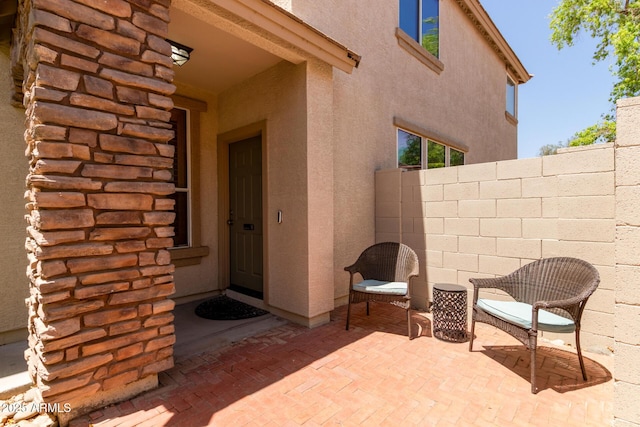 13420 W Berridge Ln, Litchfield Park, AZ 85340 - doorway to property featuring a patio, stucco siding, and fence