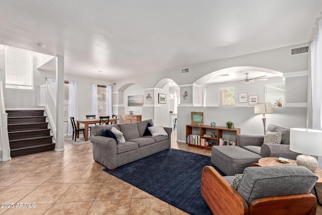 13420 W Berridge Ln, Litchfield Park, AZ 85340 - living area with arched walkways, stairway, a ceiling fan, and light tile patterned flooring