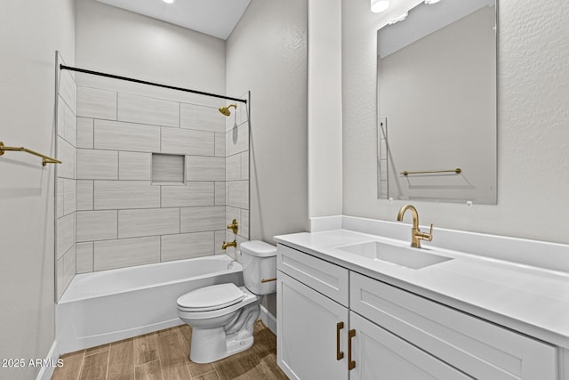 bathroom with tub / shower combination, vanity, toilet, and wood finished floors