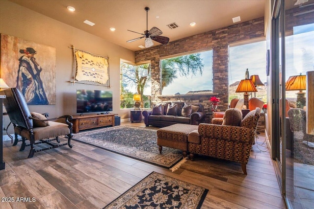 living room with hardwood / wood-style flooring and ceiling fan