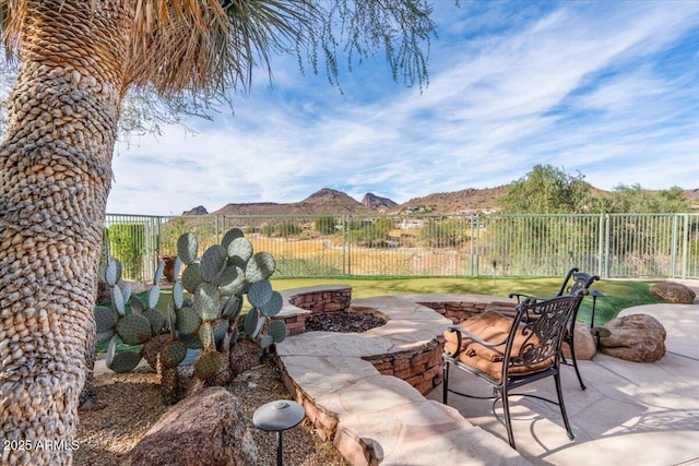 view of patio / terrace featuring a mountain view and an outdoor fire pit