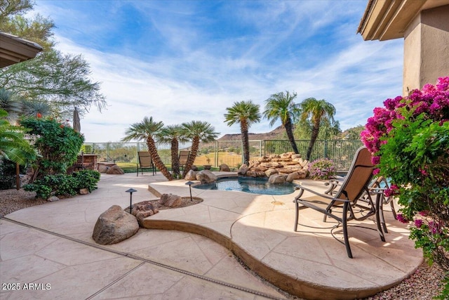 view of patio with a pool with hot tub