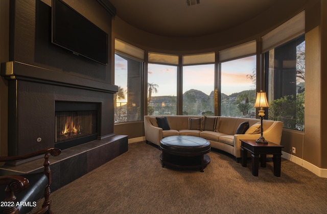 sunroom with a mountain view and a tiled fireplace