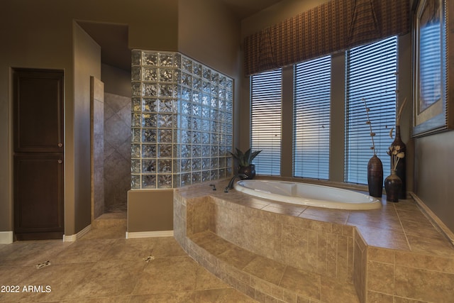 bathroom with tile patterned flooring and walk in shower