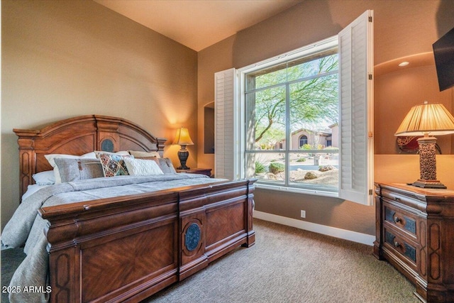 bedroom with multiple windows and light carpet