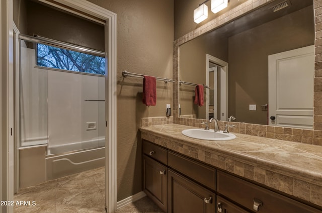 bathroom featuring washtub / shower combination and vanity