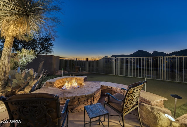 view of patio / terrace featuring a fire pit and a mountain view