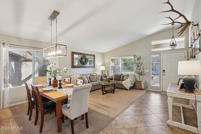 dining room with lofted ceiling, a chandelier, and tile patterned floors