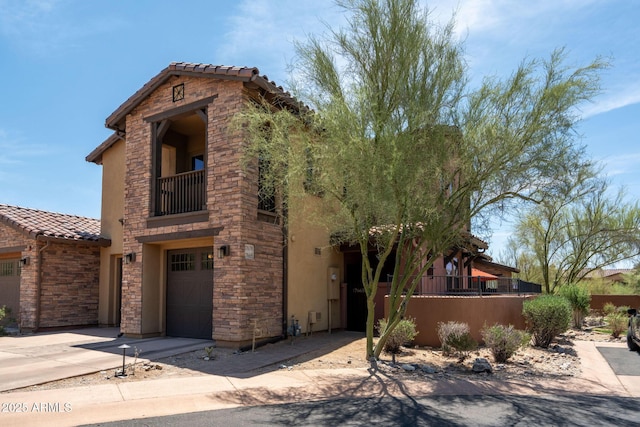 17665 N 93rd Way, Scottsdale, AZ 85255 - view of front facade featuring a balcony, an attached garage, stone siding, and a tiled roof
