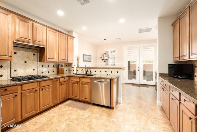 17665 N 93rd Way, Scottsdale, AZ 85255 - kitchen featuring stainless steel appliances, a sink, a peninsula, decorative backsplash, and dark stone countertops