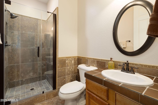 17665 N 93rd Way, Scottsdale, AZ 85255 - full bathroom with toilet, a stall shower, tile walls, vanity, and a wainscoted wall