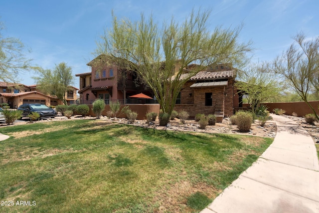 17665 N 93rd Way, Scottsdale, AZ 85255 - mediterranean / spanish home featuring a tile roof, stone siding, and a garage