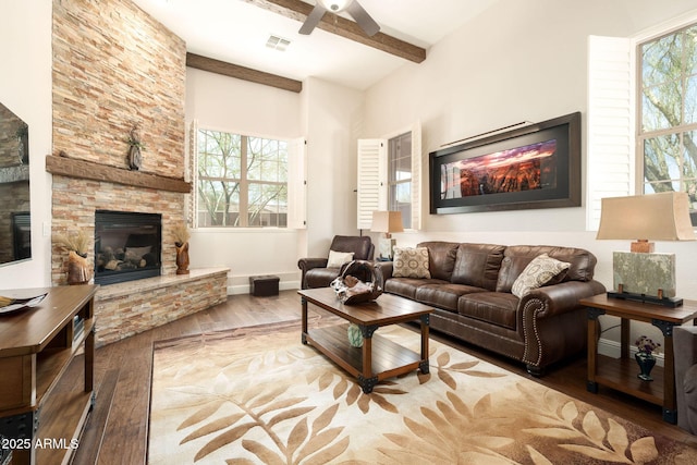 17665 N 93rd Way, Scottsdale, AZ 85255 - living area featuring a fireplace, wood-type flooring, ceiling fan, beam ceiling, and baseboards