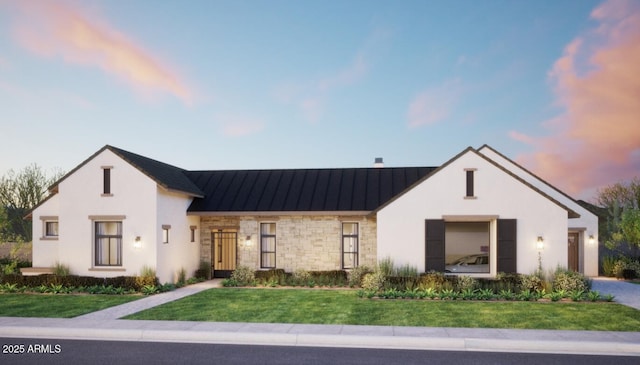 view of front facade with stone siding, stucco siding, a front yard, a standing seam roof, and metal roof