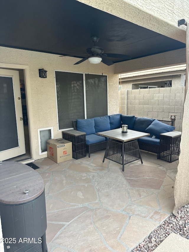 view of patio / terrace with a ceiling fan, fence, and an outdoor hangout area