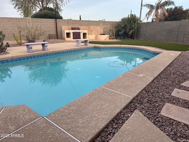 view of swimming pool with a fenced in pool, a patio area, and a fenced backyard