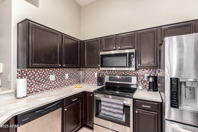 kitchen featuring stainless steel appliances, backsplash, and dark brown cabinetry