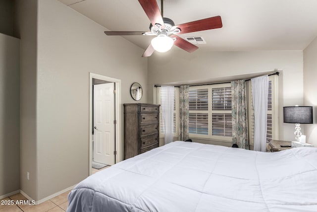 bedroom featuring lofted ceiling, ceiling fan, visible vents, baseboards, and tile patterned floors