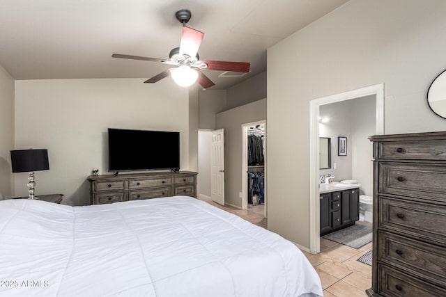 bedroom with a ceiling fan, ensuite bath, a spacious closet, a closet, and light tile patterned flooring