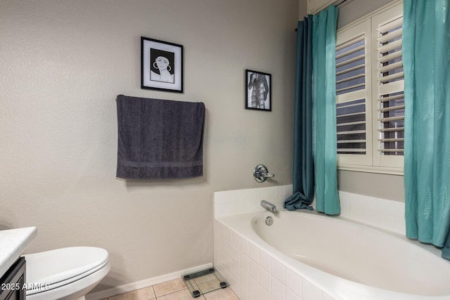 bathroom with a garden tub, toilet, vanity, tile patterned flooring, and baseboards