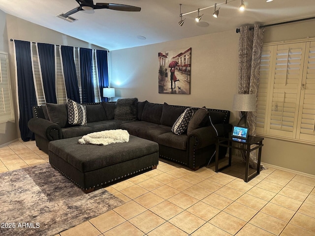 living room featuring light tile patterned floors, ceiling fan, lofted ceiling, and visible vents