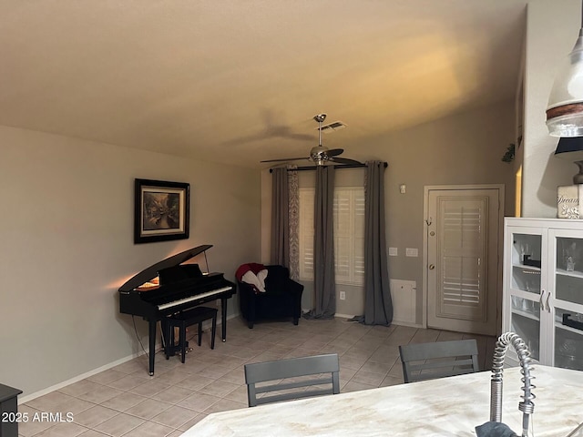 dining space with light tile patterned floors, visible vents, baseboards, lofted ceiling, and ceiling fan