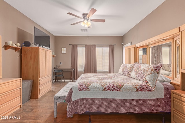 bedroom with ceiling fan and dark hardwood / wood-style floors