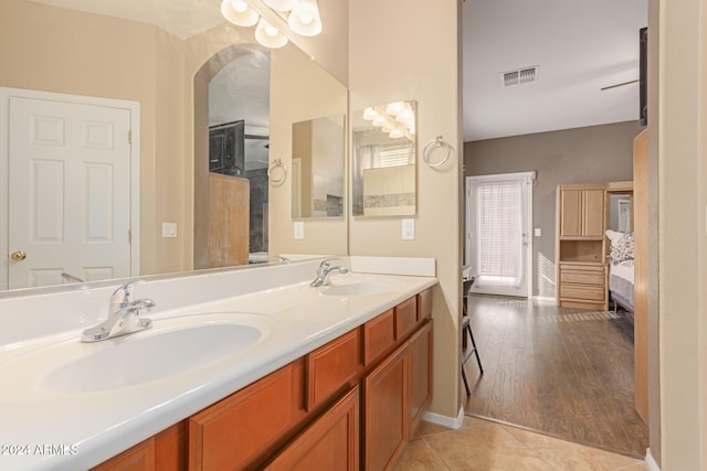 bathroom with vanity, hardwood / wood-style flooring, and ceiling fan