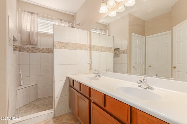 bathroom featuring tile patterned floors, vanity, a shower, and tile walls