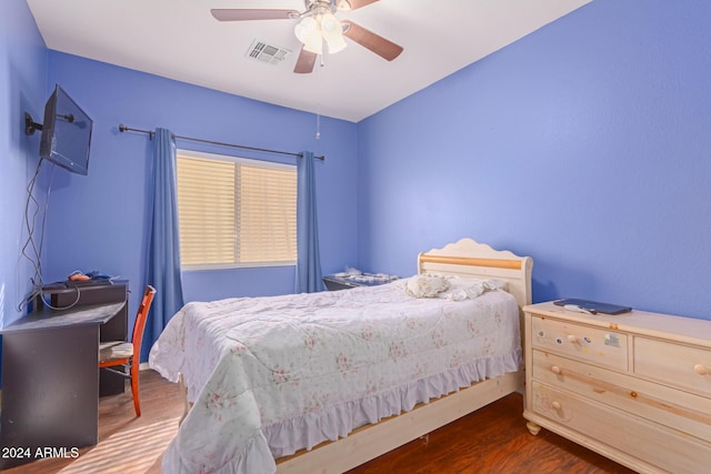 bedroom with ceiling fan and dark wood-type flooring