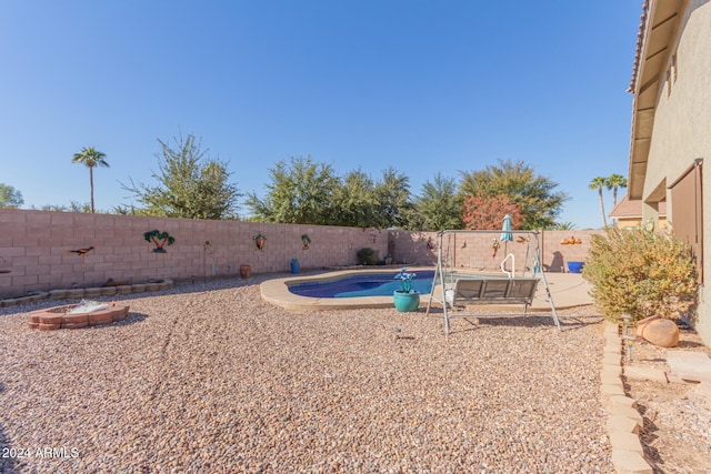 view of pool featuring a patio and an outdoor fire pit