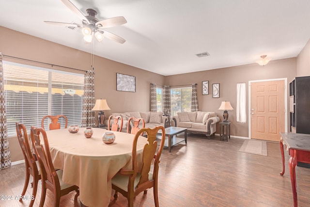 dining room featuring ceiling fan and dark wood-type flooring