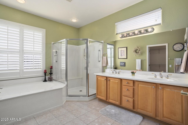 bathroom featuring tile patterned floors, shower with separate bathtub, and vanity