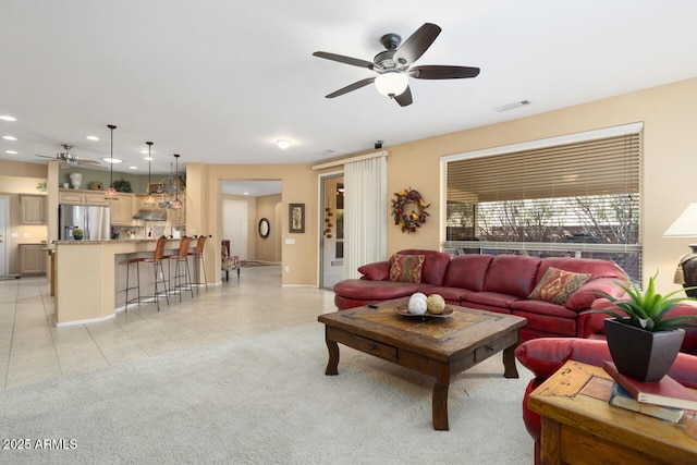 living room with ceiling fan and light tile patterned floors