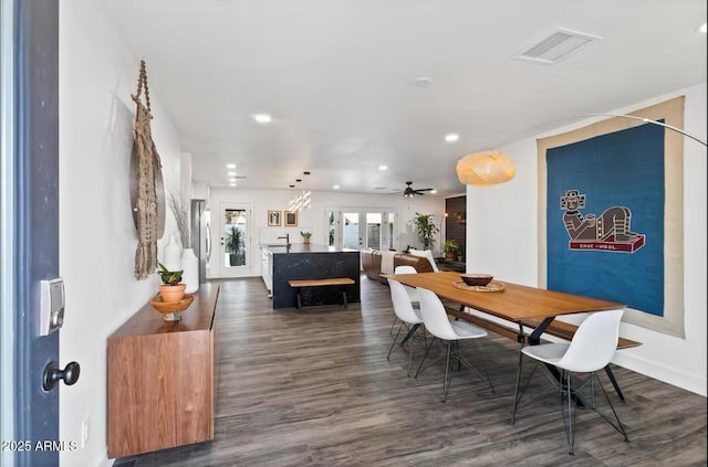 dining space featuring ceiling fan, french doors, and dark hardwood / wood-style flooring