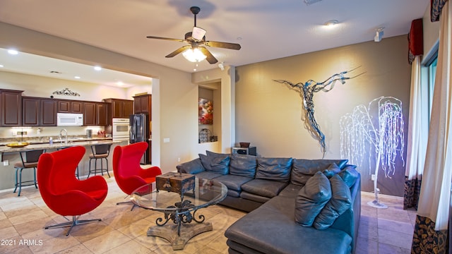 living room with ceiling fan and sink