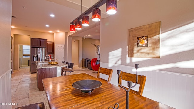 dining space featuring wooden walls and sink