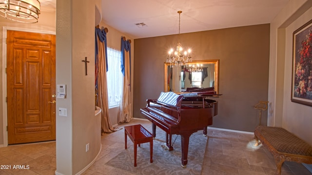 miscellaneous room featuring an inviting chandelier