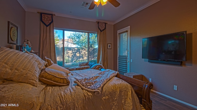 bedroom with ornamental molding, hardwood / wood-style flooring, and ceiling fan