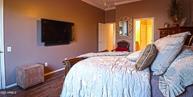 bedroom with ornamental molding, dark wood-type flooring, and ensuite bathroom